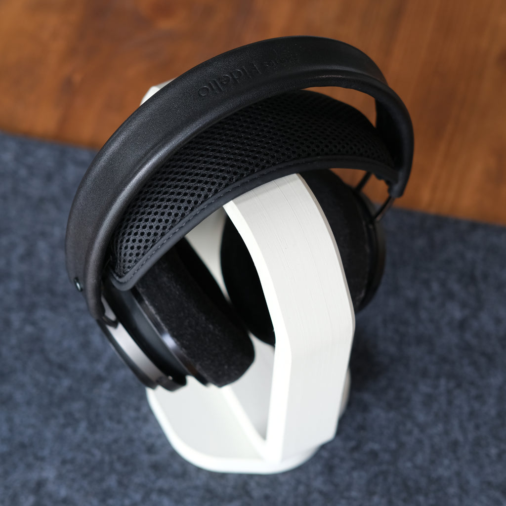 Headphone Display Stand showcasing sleek design with headphones resting stylishly on it, enhancing desk aesthetics.