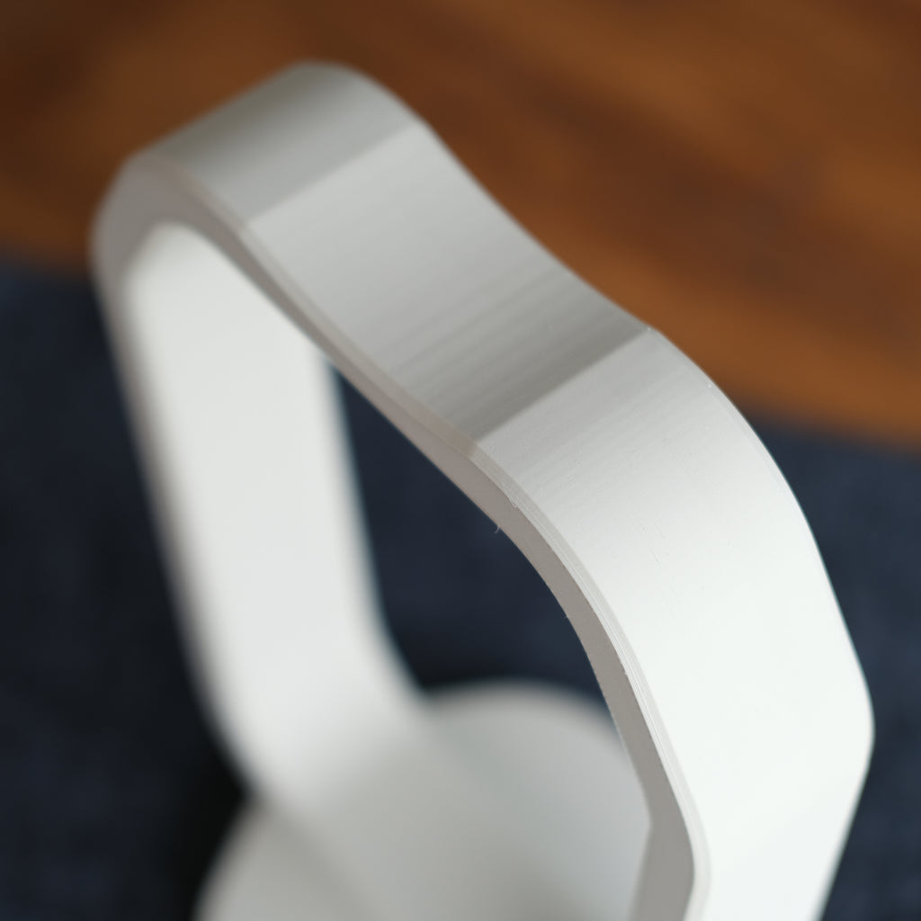 Close-up of a sleek Headphone Display Stand showcasing its modern design and smooth finish.